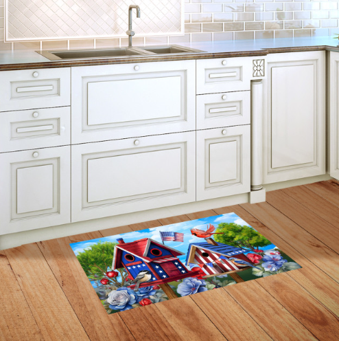 Decorative mat with a colorful design on a wooden floor in a kitchen.