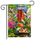 Decorative garden flag with colorful hummingbirds and a bird feeder on a white background