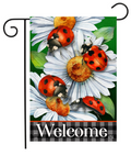 Decorative garden flag with ladybugs and daisies and the word 'Welcome'.