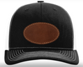 Black cap with a brown leather patch on a white background