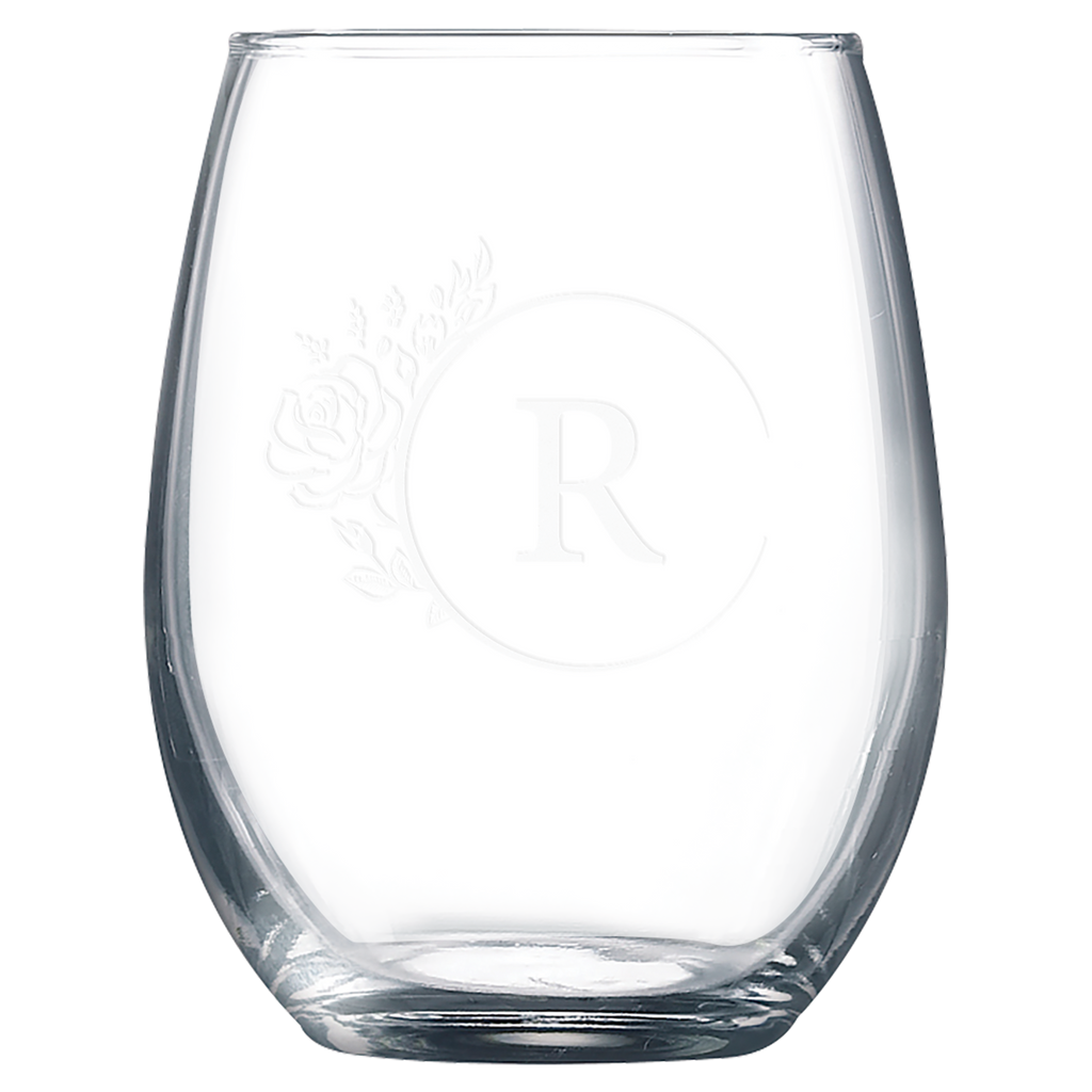 Clear glass tumbler with laser engraved design on a white background