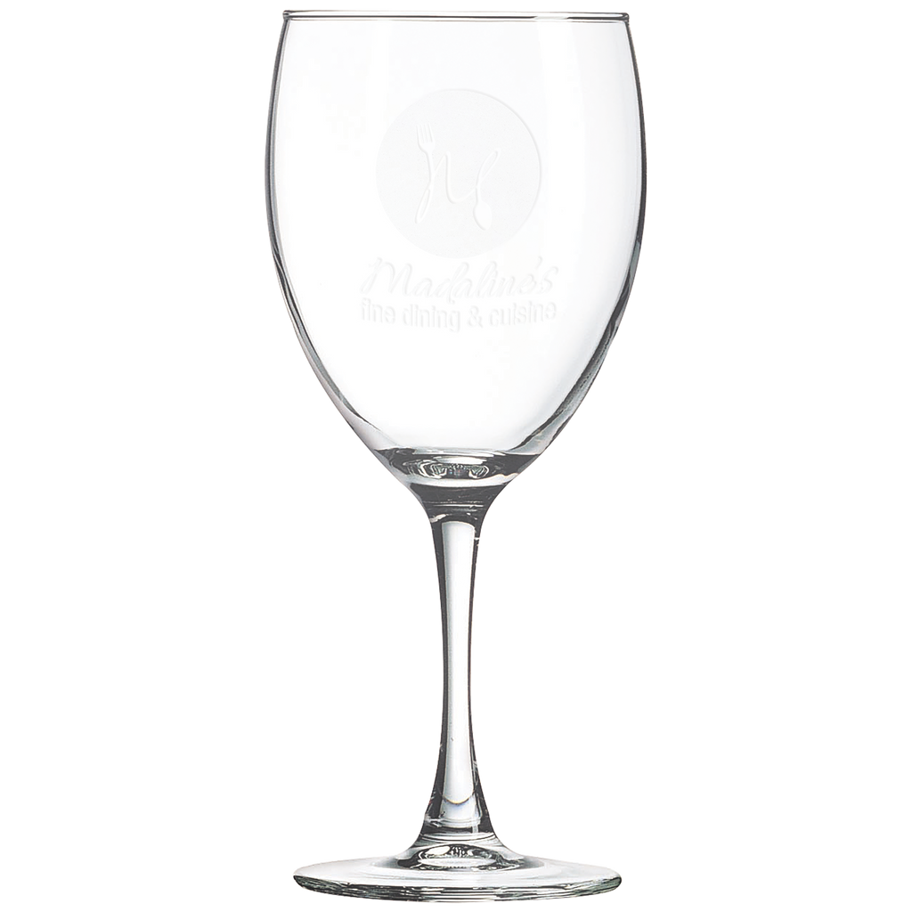Clear wine glass with laser engraved design on a white background