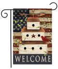 Decorative garden flag with birdhouses, cardinal, and American flag design on a wooden background.