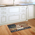 Kitchen with a decorative doormat featuring an American flag design on a wooden floor.