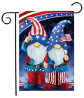 Decorative flag with two gnome characters wearing American flag hats and pants, holding a flagpole with an American flag.