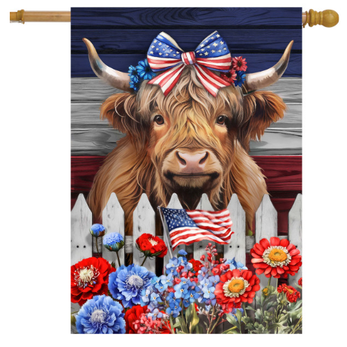 Decorative flag with a cow wearing an American flag bow, flowers, and an American flag in front of a wooden fence.