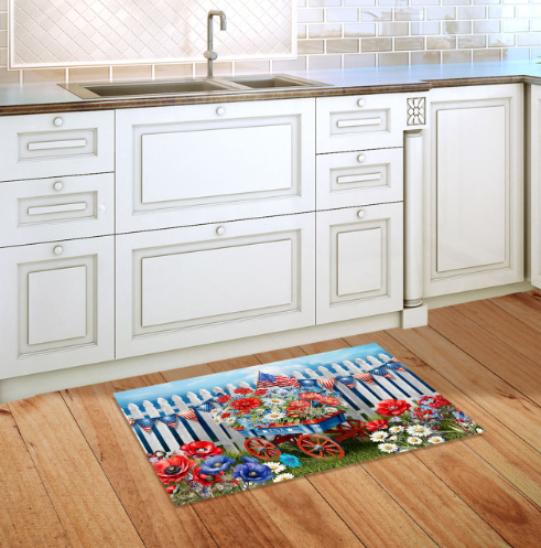 Decorative rug with floral and wagon design on a wooden floor in a kitchen.