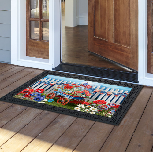 Decorative doormat with floral and garden design on a wooden floor.