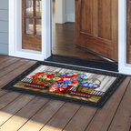 Decorative doormat with floral design on a wooden floor outside a house.