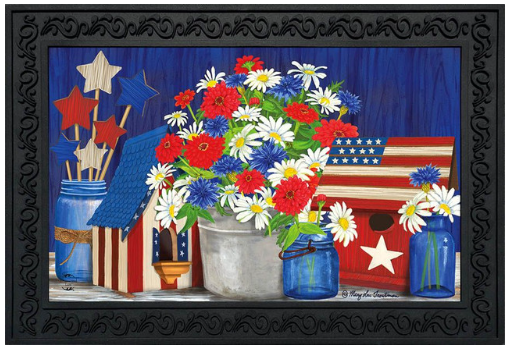 Decorative mat with flowers, stars, and an American flag design on a blue background.