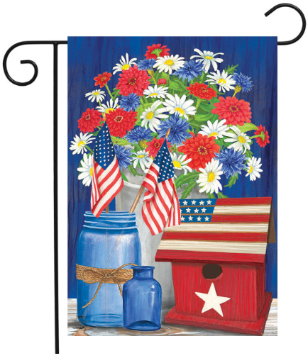 Decorative garden flag with flowers, American flags, and a birdhouse on a blue background.