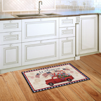 Decorative doormat with a red truck and 'Welcome' text on a wooden floor in a kitchen.