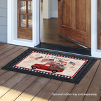 Decorative doormat with a red truck and American flags on a wooden floor.