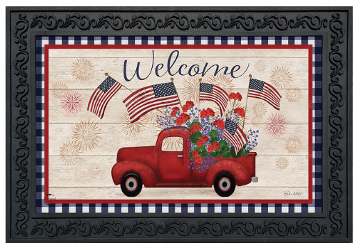 Decorative mat with a red truck, American flags, and flowers on a wooden background with 'Welcome' text.