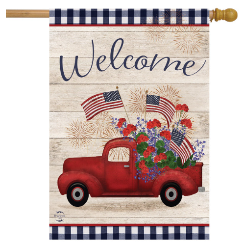 Decorative flag with a red truck, American flags, and flowers on a wooden background with 'Welcome' text.