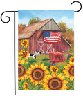 Decorative flag with a barn, American flag, tractor, and sunflowers.