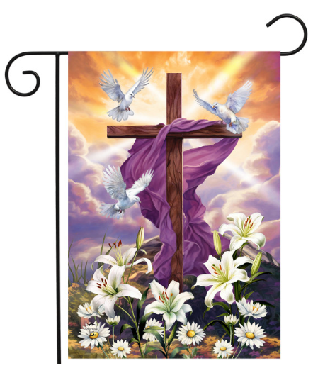 Decorative flag with a cross, doves, and flowers against a colorful sky.