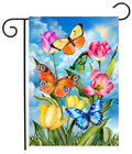 Decorative garden flag with colorful butterflies and tulips against a blue sky.