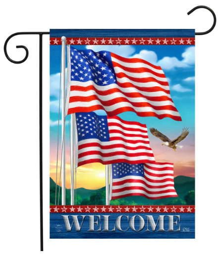 Decorative flag with American flags and an eagle, featuring the word 'Welcome', on a blue sky background.