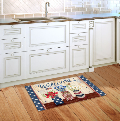 Decorative doormat with 'Welcome' text on a wooden floor in a kitchen.