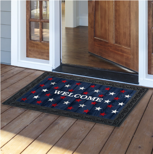 Decorative doormat with star pattern and 'Welcome' text on a wooden floor.