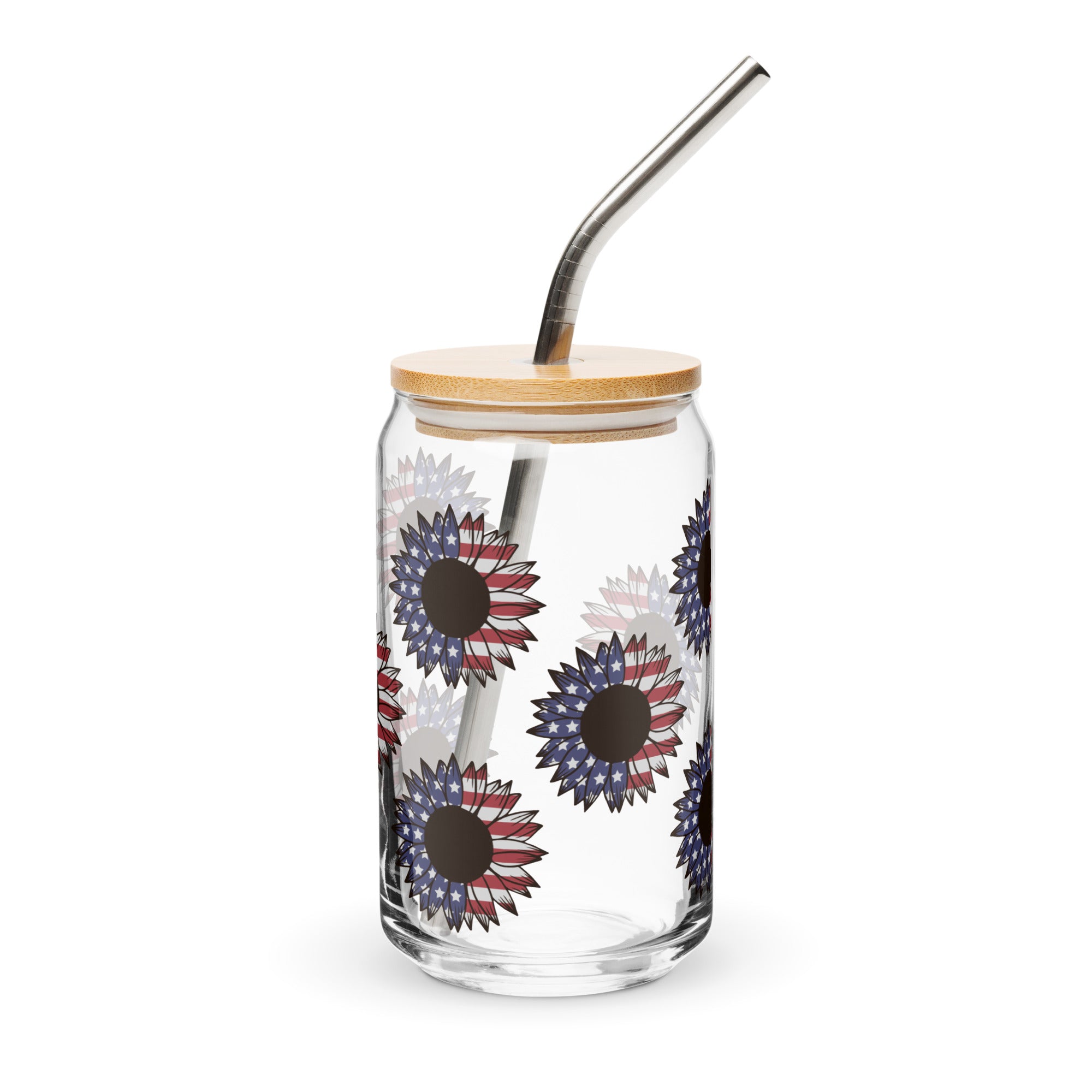 Clear glass tumbler with floral design, wooden lid, and metal straw on a white background