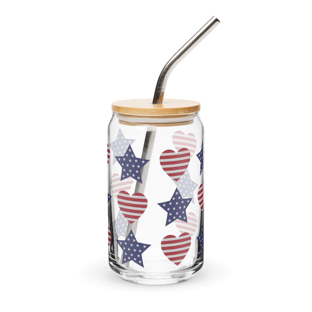 Glass tumbler with star and heart pattern, wooden lid, and metal straw on a white background