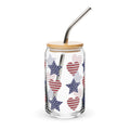 Glass tumbler with star and heart pattern, wooden lid, and metal straw on a white background
