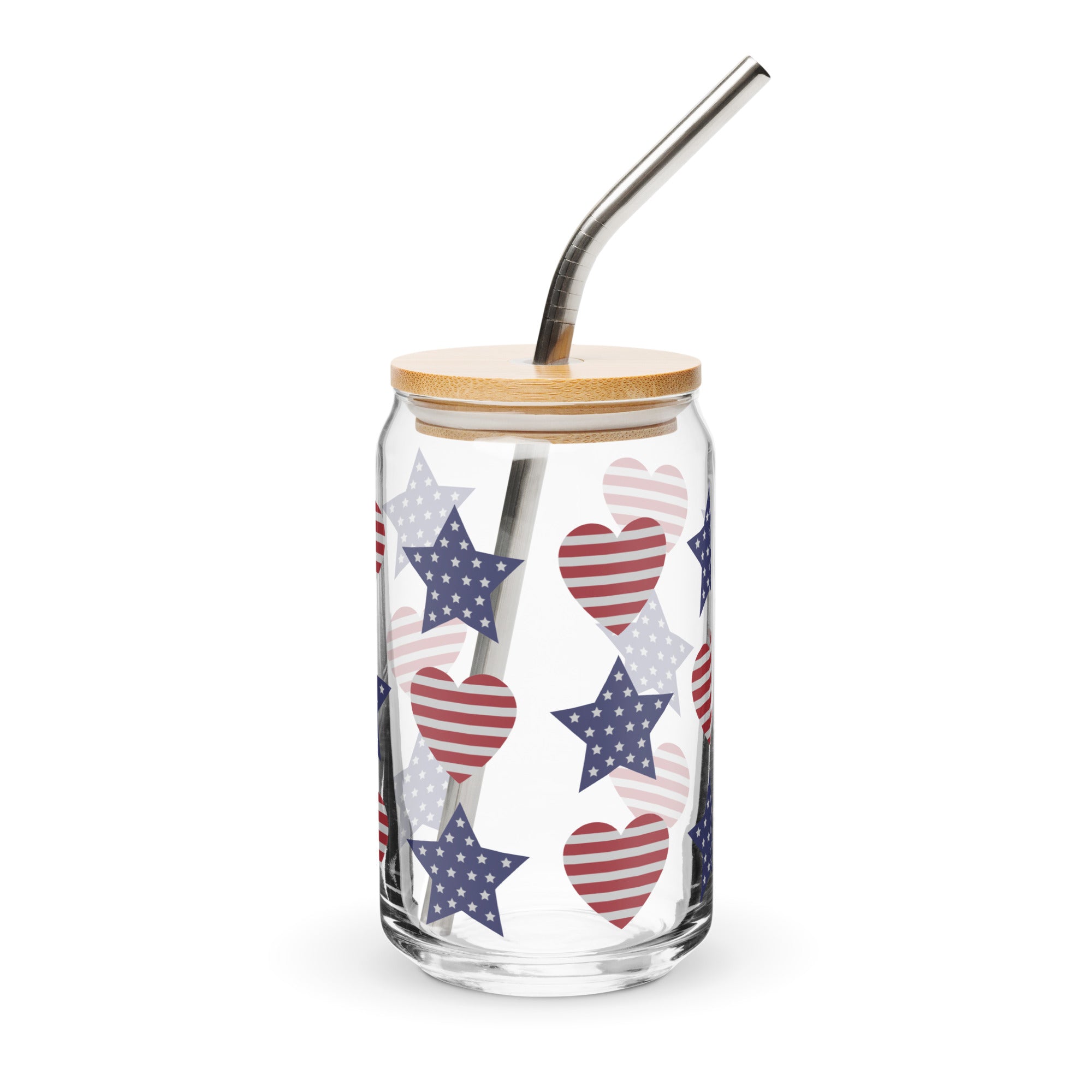 Glass tumbler with star and heart pattern, wooden lid, and metal straw on a white background