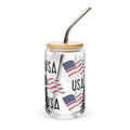 Glass tumbler with USA text and American flags design, bamboo lid, and metal straw on a white background.