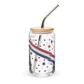 Glass jar with star and stripe pattern, wooden lid, and metal straw on a white background