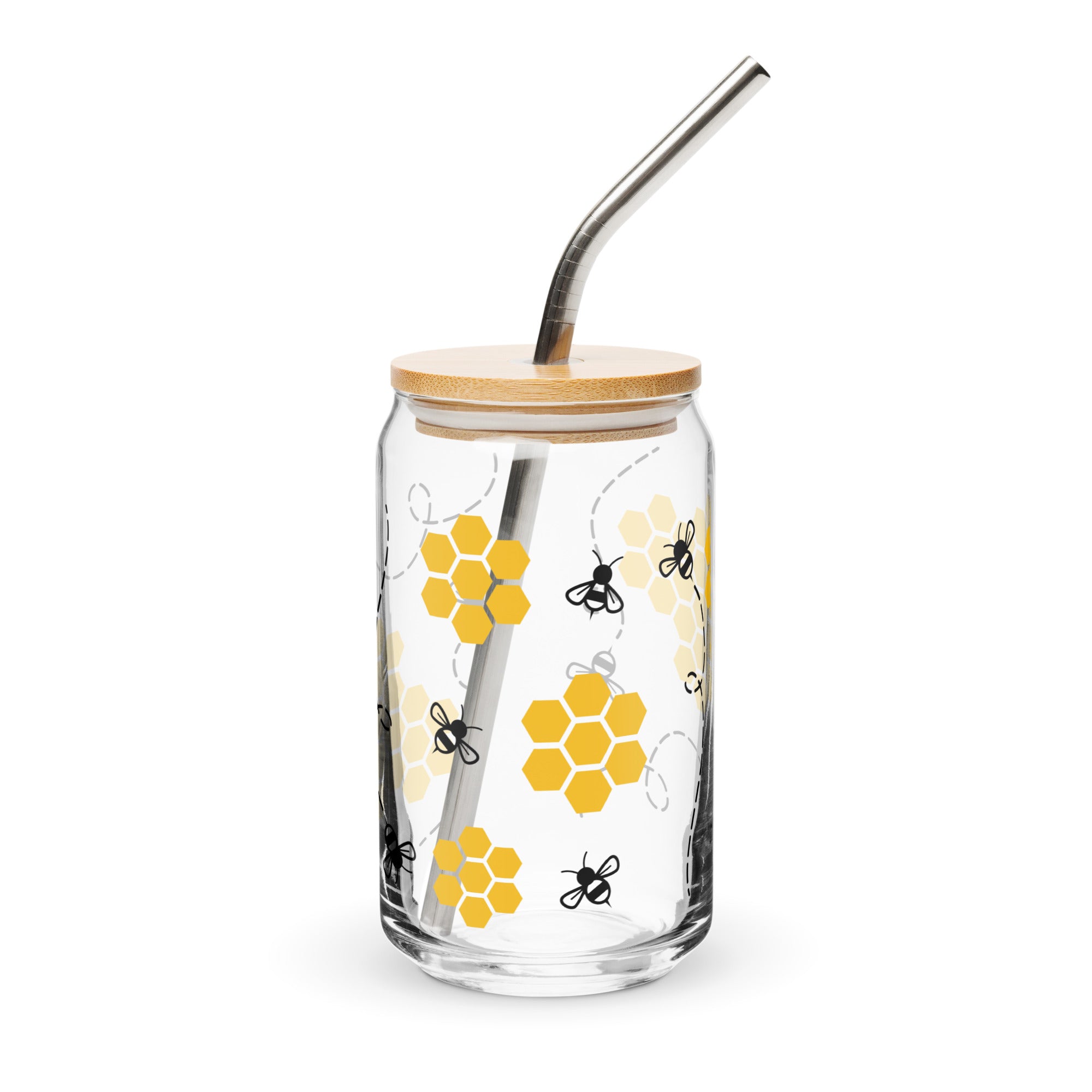 Glass tumbler with bamboo lid and metal straw featuring honeycomb and bee design on a white background