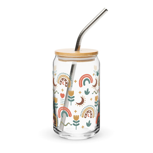 Glass tumbler with a bamboo lid and metal straw featuring colorful patterns on a white background.