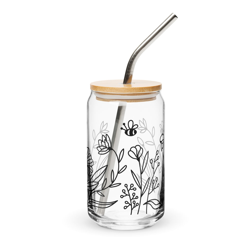 Clear glass tumbler with bamboo lid and metal straw, featuring black line art of flowers and a bee on a white background.