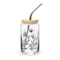 Clear glass tumbler with bamboo lid and metal straw, featuring black line art of flowers and a bee on a white background.