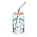 Clear glass tumbler with dragonfly design, wooden lid, and metal straw on a white background