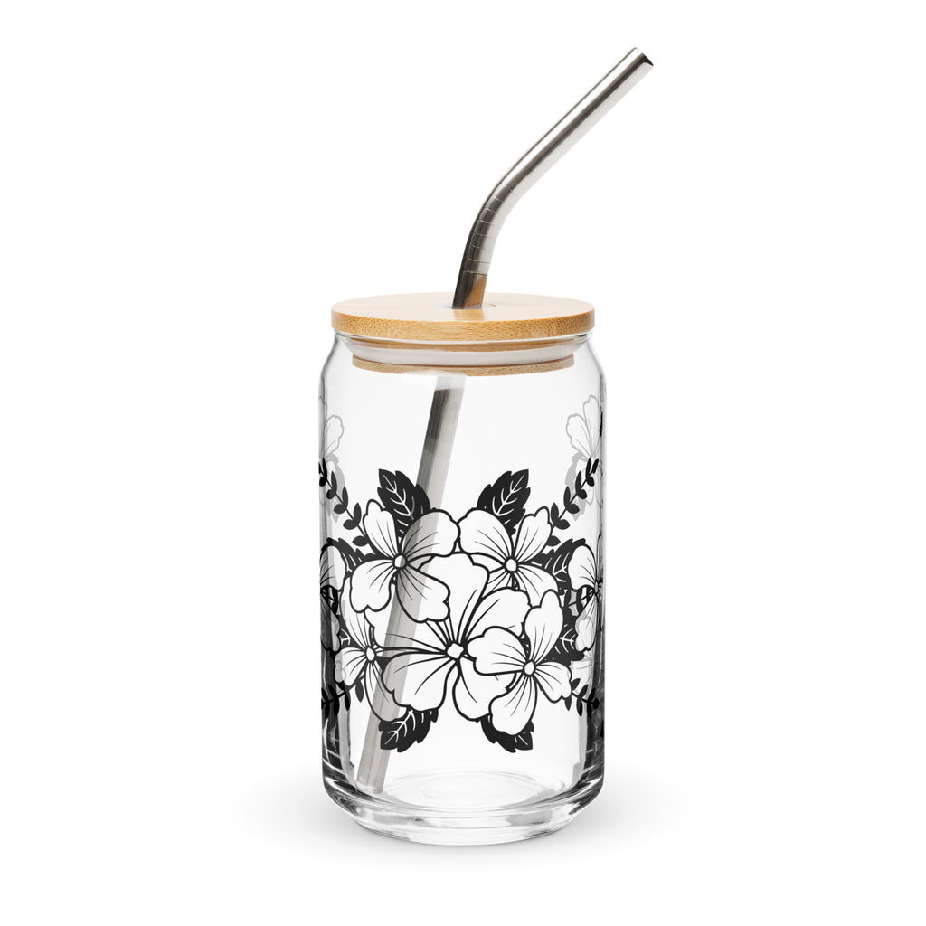 Glass tumbler with floral design, wooden lid, and metal straw on a white background