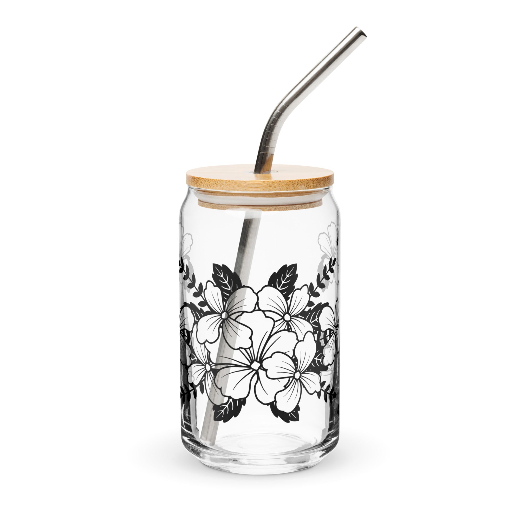 Glass tumbler with floral design, wooden lid, and metal straw on a white background
