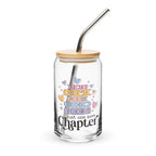 Glass tumbler with bamboo lid and metal straw, featuring colorful book illustrations and 'just one more chapter' text.