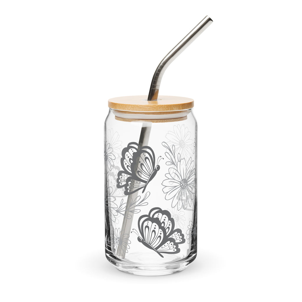 Clear glass tumbler with butterfly design, wooden lid, and metal straw on a white background