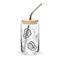 Clear glass tumbler with butterfly design, wooden lid, and metal straw on a white background