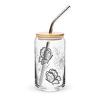 Clear glass tumbler with butterfly design, wooden lid, and metal straw on a white background