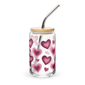 Glass tumbler with heart pattern, wooden lid, and metal straw on a white background