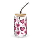 Glass tumbler with heart pattern, wooden lid, and metal straw on a white background
