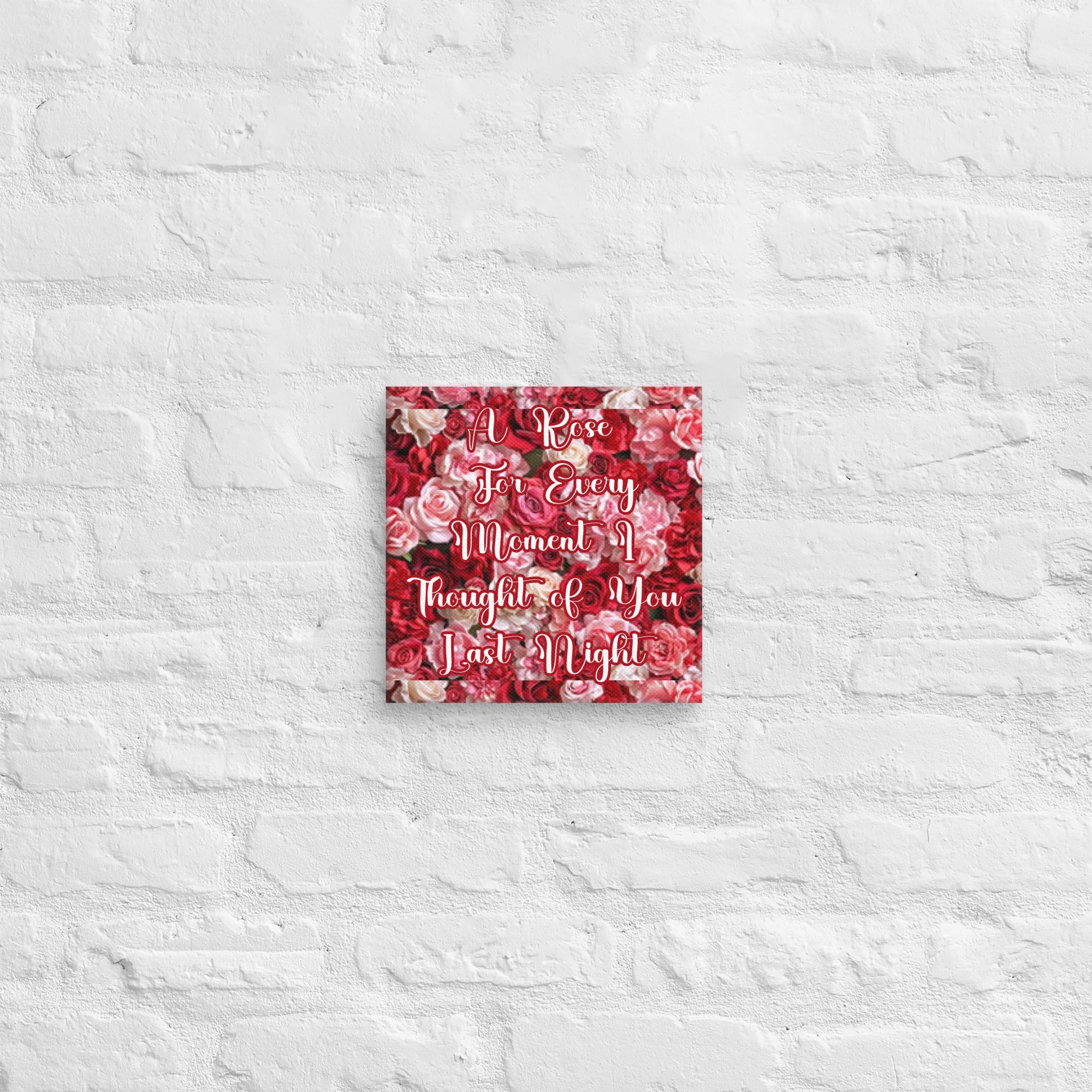 Decorative wall art with floral pattern and text on a textured white wall.