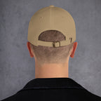 Beige cap back on a person with a gray background