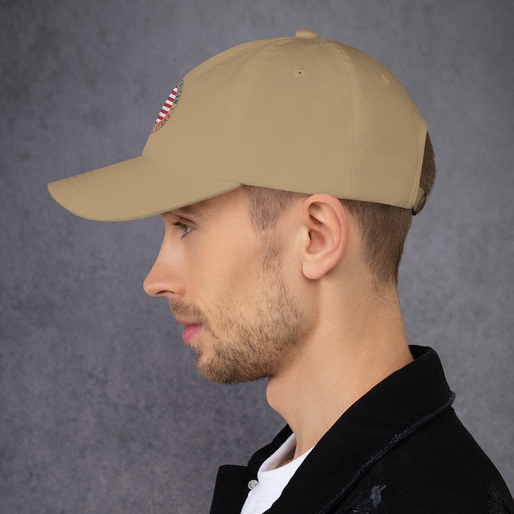 Man wearing a beige cap against a gray background