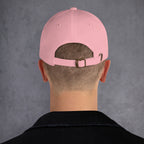 Person wearing a pink cap back with a gray background