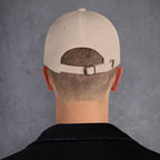 Beige cap back on a person with a gray background