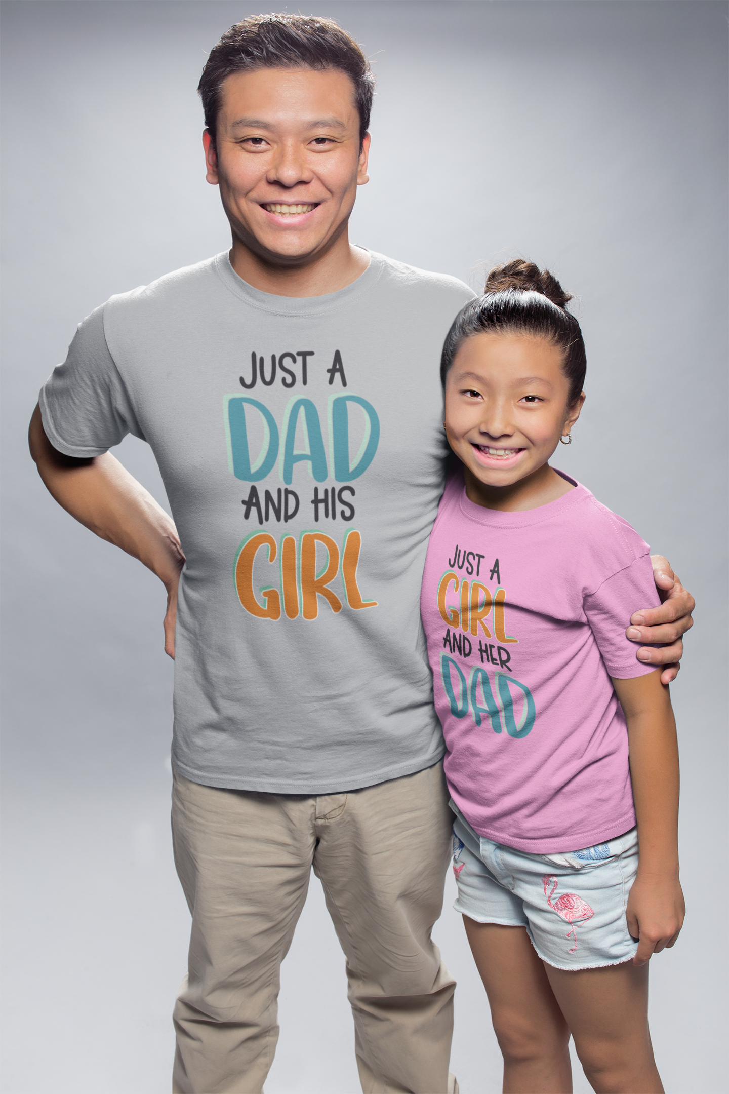 Dad hugging his daughter in a photo studio wearing matching shirts “Just a Dad and His Girl” and “Just a Girl and Her Dad”